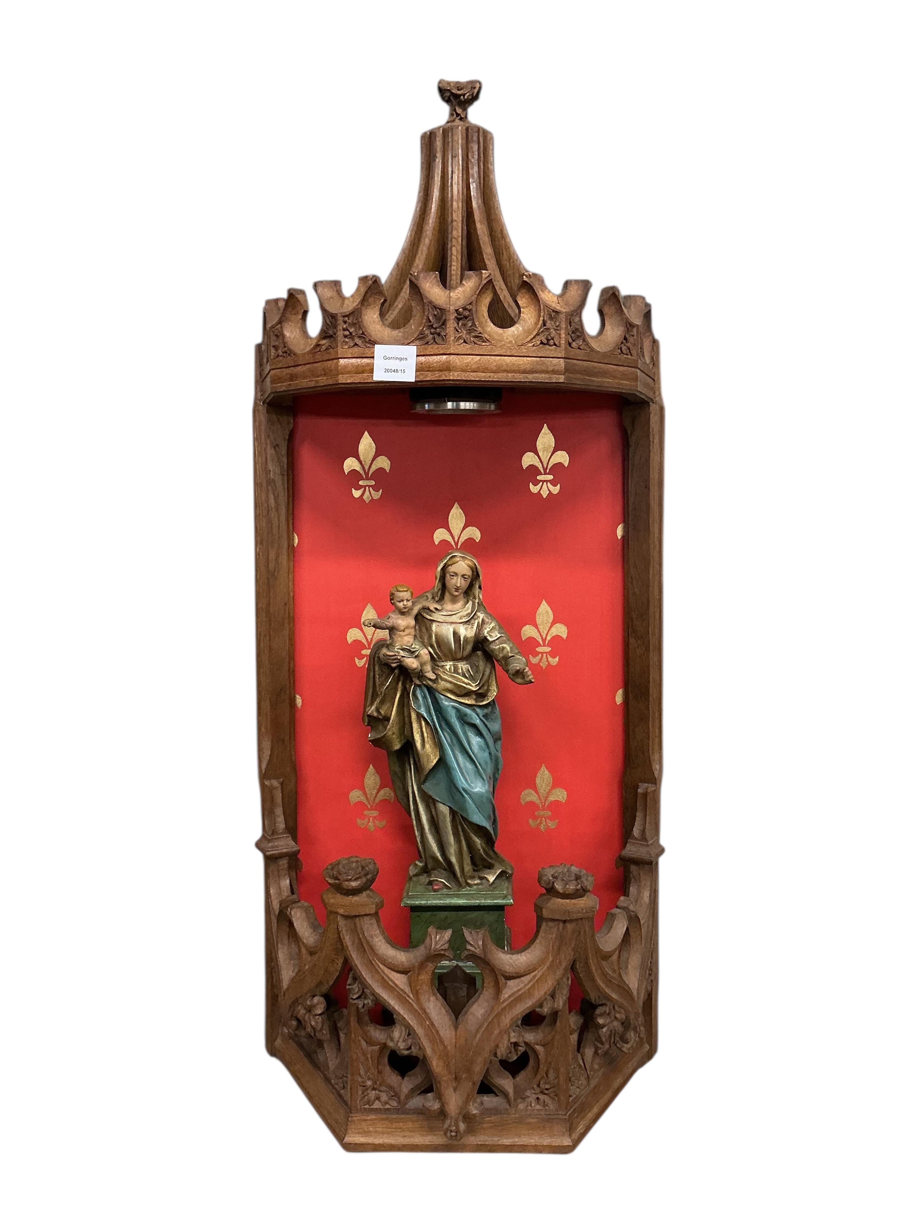 A Gothic Revival carved oak niche with plaster Madonna and child, height 104cm